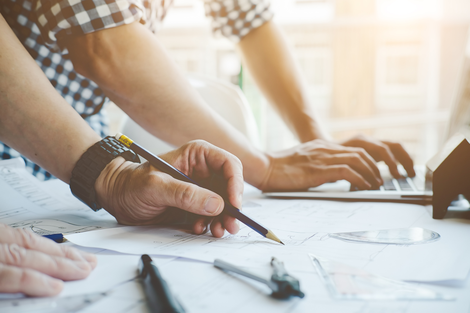 Architects Working in Office with Blueprints