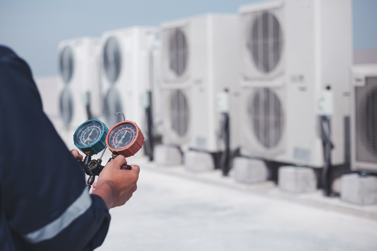 Technician is checking air conditioner ,measuring equipment for filling air conditioners.